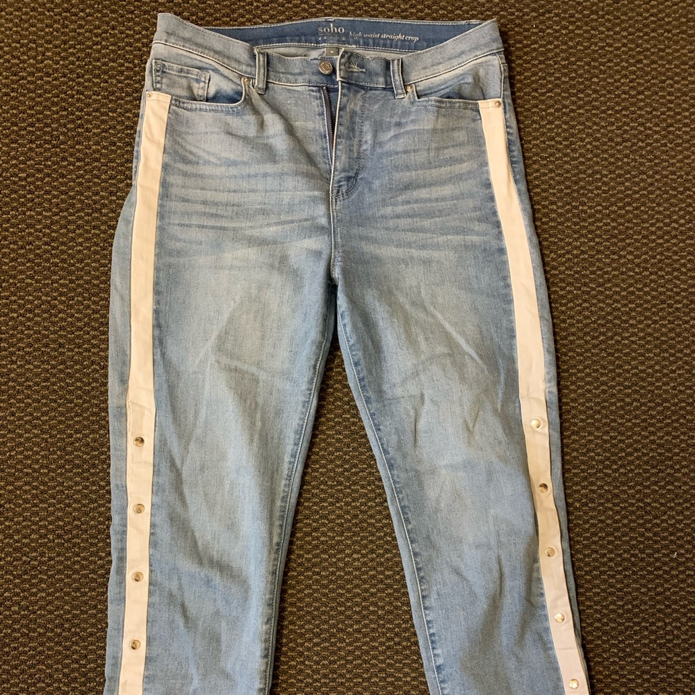 Pants with white lines and buttons on the side